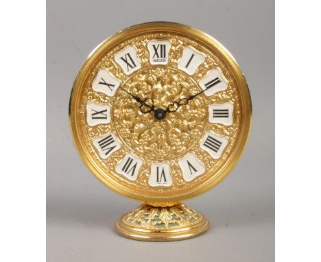 A mid 20th century gilt metal Jaeger alarm clock. Having scrollwork decoration, and Roman numeral markers. Height 10cm.  Work