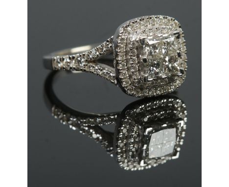 A 14ct white gold diamond cluster ring. The four central square cut diamonds with double halo surround and having diamond set
