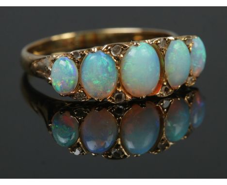 A gold and five stone opal ring. Tests as high carat. Size L. 3.44g.  