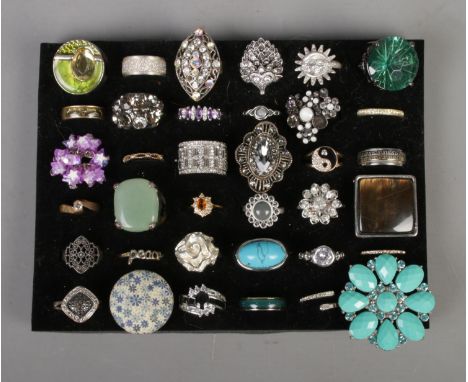 A collection of 36 dress rings to include two silver rings. Includes hedgehog, spinner, half eternity and mood ring examples.