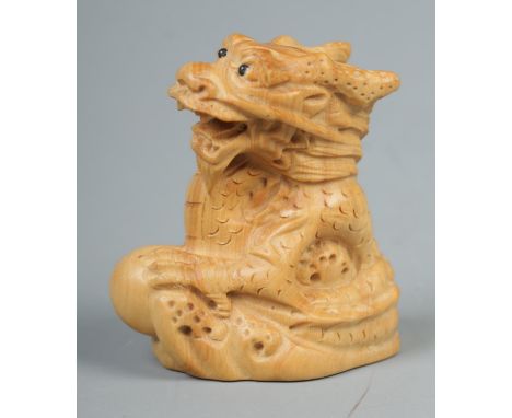 A Japanese carved Netsuke in the form of a dragon  