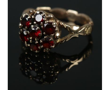 A 9ct gold garnet cluster ring. Size O. 4.53g.  
