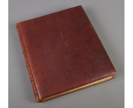 A leather album of scraps with gilding finish to paper and covers fill with mostly Victorian scraps of various themes includi