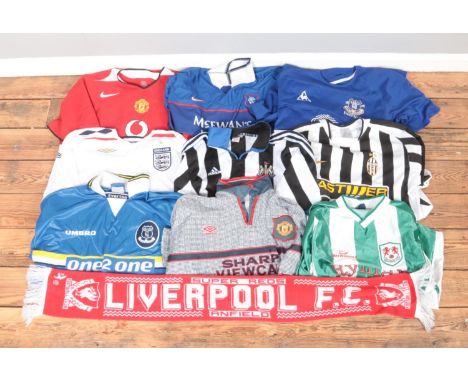 A collection of replica football shirts including Manchester United, England, Everton, Millwall, Juventus, Newcastle together