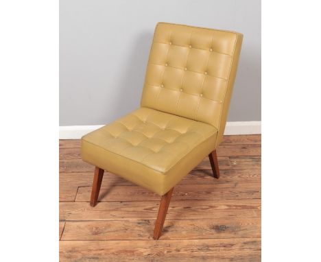 A vintage Scandinavian style beige leatherette chair with teak legs.  