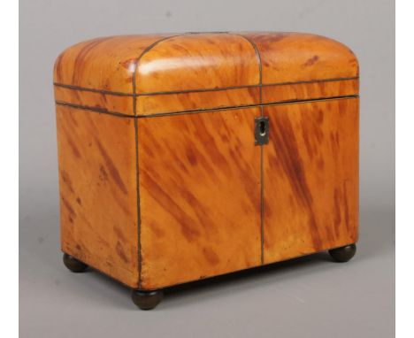 A 19th century tortoiseshell tea caddy. Raised on four metal ball feet and having ivory handles. Ivory Submission reference 3