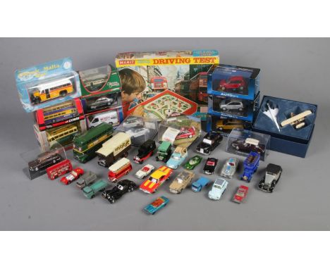 A box of assorted diecast vehicles to include Corgi, Auto Art, Lesney, etc. Also include boxed Merit Remote Control Driving T