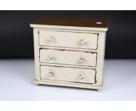 A vintage painted 3 drawer table top chest. Measures approx 29cm W x 26.5cm H 