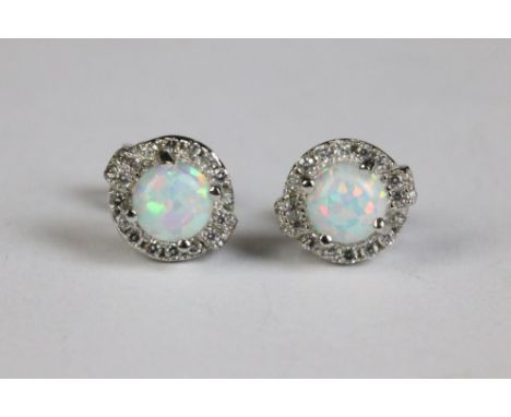 A pair of silver and opal and CZ stud earrings 