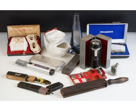 A collection of shaving related collectables to include cut throat and electric examples together with sharpening tools and a