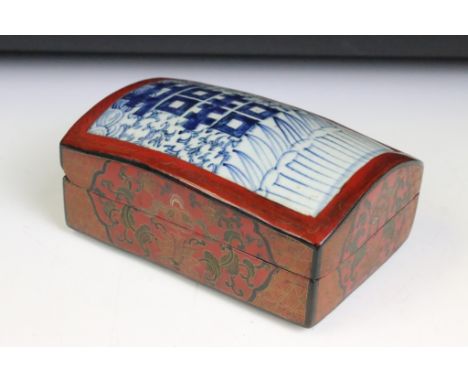 Chinese red lacquered box with gilt details and blue &amp; white ceramic panel to lid, approx 17.5cm long x 12cm wide 