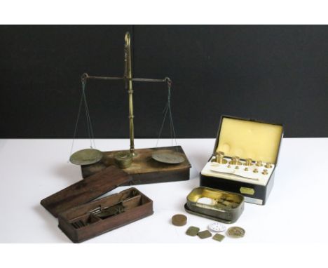 A collection of scales to include a set of opium scales within a wooden case together with a quantity of weights. 