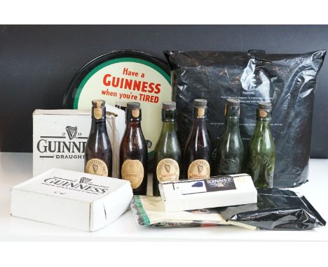 Advertising - A quantity of Guinness collectables to include a drinks tray, 6 x vintage empty Guinness bottles, Christmas sto