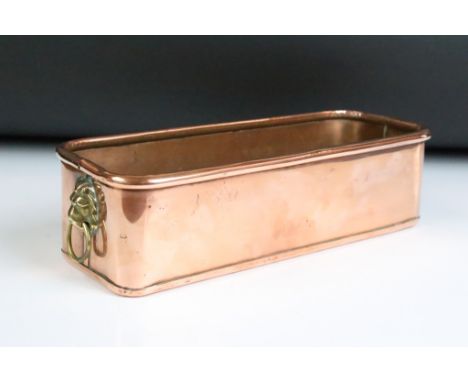 Copper rectangular planter, with twin lion mask handles, roller upper rim. Approx 30cm long 