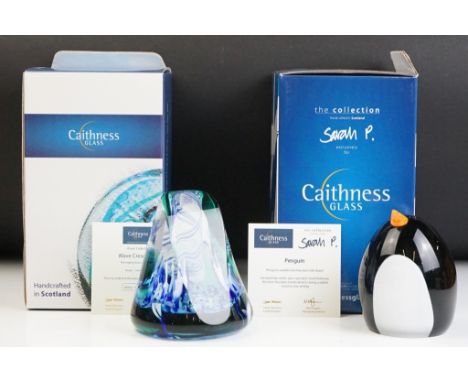 Two boxed Caithness glass paper weights to include a penguin designed by Sarah Peterson (with certificate) and Wave Crescendo