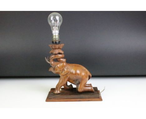 Indian carved hardwood table lamp in the form of an elephant (measures approx 32.5cm high - including bulb) 
