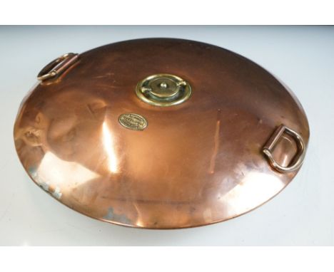 Early 20th Century copper automobile foot warmer having twin swing handles with brass instruction panel. Measures 42cm diamet