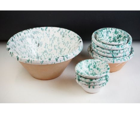 Collection of Italian ceramic terracotta bowls, each having a white glazed ground with green speckled detailing. Largest bowl