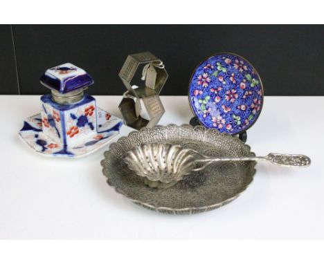 A small group of mixed collectables to include hallmarked silver napkin rings, a white metal oriental tea strainer with chara