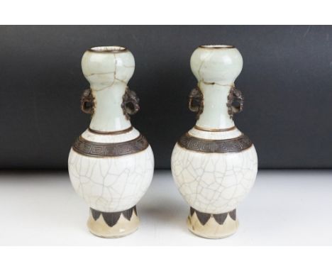 Pair of Chinese celadon crackle glaze vases. The vases having celadon glazed necks, crackle glazed bodies, twin lion mask han