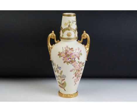 Victorian Royal Worcester twin handled ivory blush vase with gilt and floral detailing. Puce mark to the base. Measures 32cm 