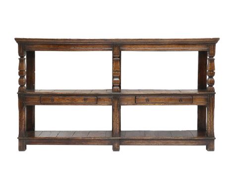 A Late 17th Century Oak Cup-Board or Buffet, the boarded top of nailed construction with a moulded frieze above baluster supp