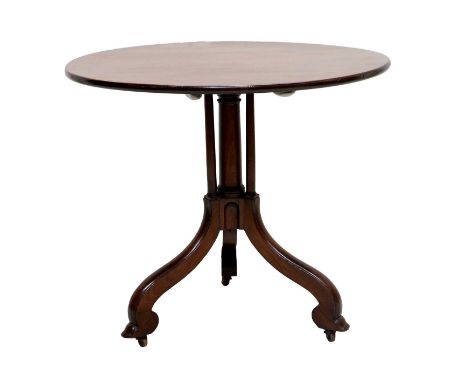 A George III Mahogany Circular Tripod Table, the flip-top on a central tapering column support flanked by three smaller colum