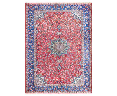 Nejafabad Isfahan CarpetCentral Iran, circa 1970The blood red field of scrolling vines around a pistachio green flowerhead me