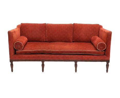 A Carved Mahogany Three-Seater Sofa, late 19th/early 20th century, recovered in red and cream geometric fabric, with three ba