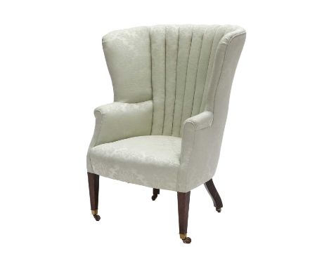 A George III Barrel-Shaped Wing-Back Chair, early 19th century, recovered in light green floral silk damask, the flared sides