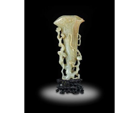 ~ A Chinese Pale Celadon and Russet Jade Vase, Qing Dynasty, 18th century, as a trumpet-shaped flowerhead carved with bats an