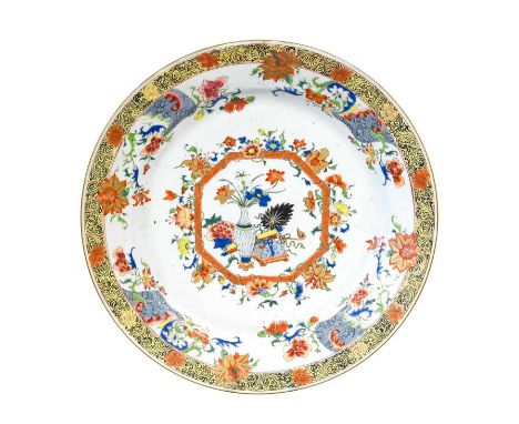 A Chinese Porcelain Dish, early Qianlong, of circular form, painted in famille rose enamels with precious objects within an o