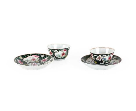 ~ A Pair of Chinese Porcelain Tea Bowls and Saucers, Yongzheng, painted in famille rose enamels with flowersprays in panels o