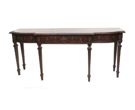 An Edwardian Carved Mahogany Adam-Style Serving Table, early 20th century, of breakfront form, the moulded top with guilloche