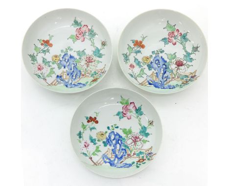 Depicting scene in garden in Famille Rose enamels with gilt accents, 21 cm. in diameter, chip and hairline.