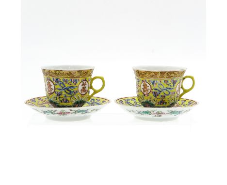 Decorated with Chinese characters and symbols, Guangxu mark, saucers are 12 cm. in diameter, fritting on edges.