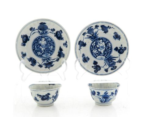 Blue and white decor depicting Chinese boy in center with floral decor, saucers are 12 cm. in diameter, 1 cup restored.