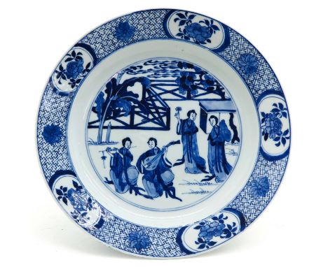 Kangxi Period, depicting Chinese ladies in garden with muscial instruments, 27 cm. in diameter, fritting and hairline.