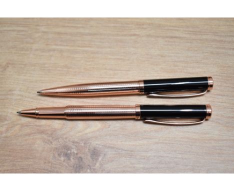 A boxed Stratton rollerball and ballpoint pen set in black and rose gold.