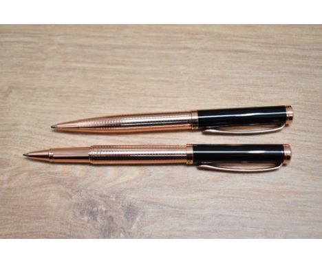 A boxed Stratton rollerball and ballpoint pen set in black and rose gold.