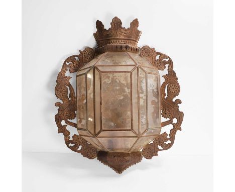An embossed metal wall lantern, late 19th/early 20th century, surmounted with a crown over pierced side panels, with a panell