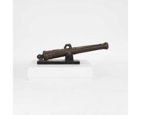 A bronze signal cannon, 18th century, Dutch, the ring-turned barrel cast with dolphin lug mounts and a coat of arms, raised o