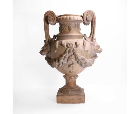 A neoclassical terracotta urn by Jean Garouste, late 19th century, French, with elongated scroll handles terminating in lion 