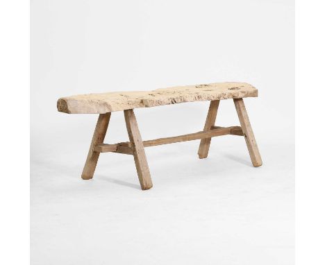 A rustic olivewood bench, of recent manufacture, the rustic top raised on end supports, united by stretchers,130cm wide37cm d