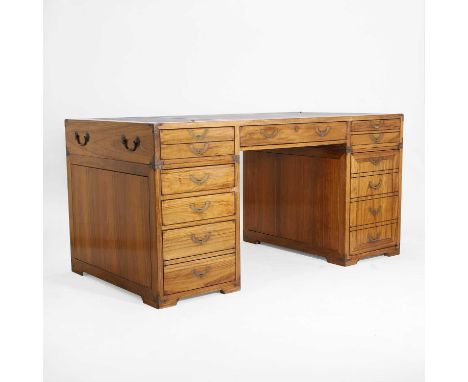 A teak and brass-mounted pedestal desk by Starbay, of recent manufacture, the leather inset top fitted with a hinged compartm