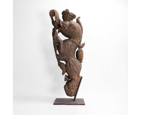 A carved wooden corbel, 20th century, South Asian, modelled as an elephant with eagle feathers, 26cm wide15cm deep66cm high