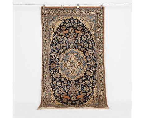A wool rug, 20th century, central Persia, the central navy field decorated with scrolling foliage, birds and deer,335 x 125cm