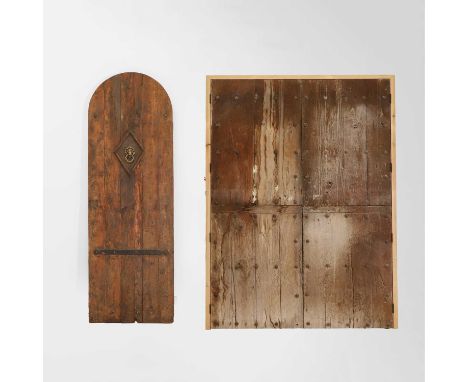 An arched panelled door, iron-bound, with a lion-shaped door knocker, 71cm wide212cm high,together with another large panelle