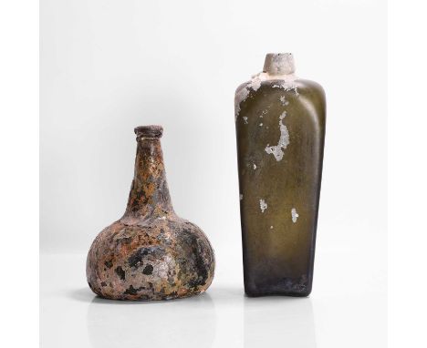 Two shipwreck items of glass comprising a 'horse hoof' onion bottle, early 18th century, and a tapered spirit bottle, 19th ce