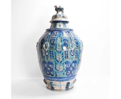 A large delft vase and cover, early to mid-20th century, in the Isnik taste, the cover with a camel finial, the ovoid body mo